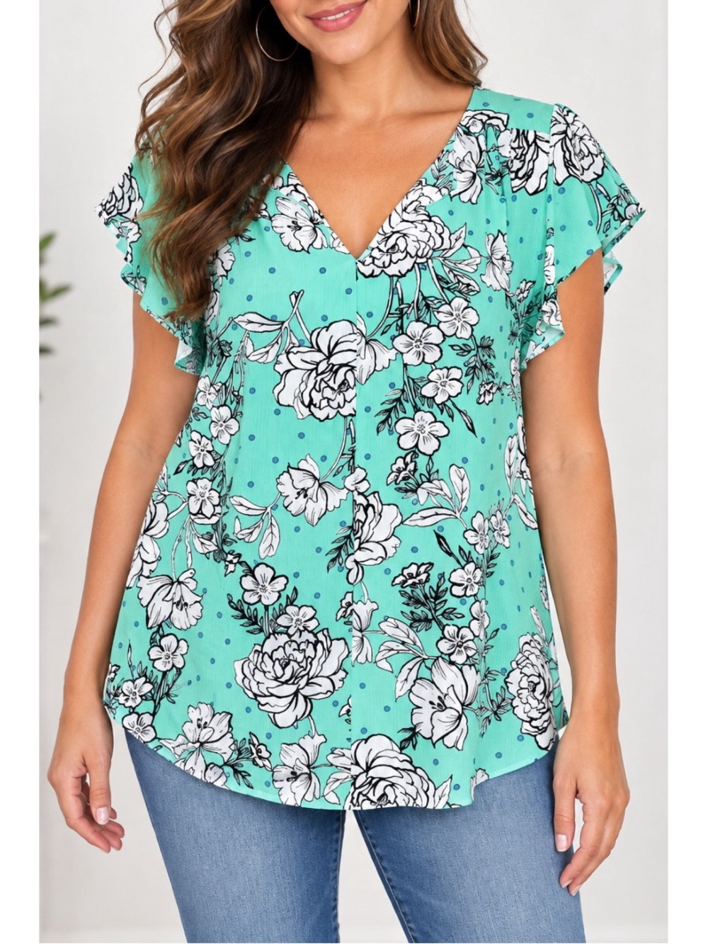 Elle mint-aqua floral blouse features an all-over black-and-white floral print